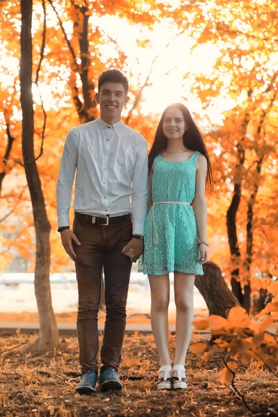 Casal jovem em um passeio no parque de outono — Fotografia de Stock