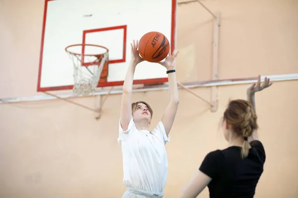 Menina no ginásio jogando uma bola de basquete — Fotografia de Stock