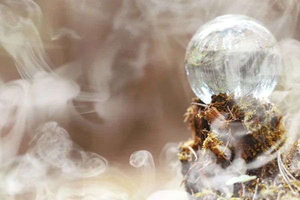 A crystal ball in the smoke. A magical accessory in the woods on — Stock Photo, Image