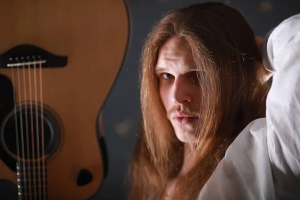 Jovem com cabelo comprido e guitarra — Fotografia de Stock