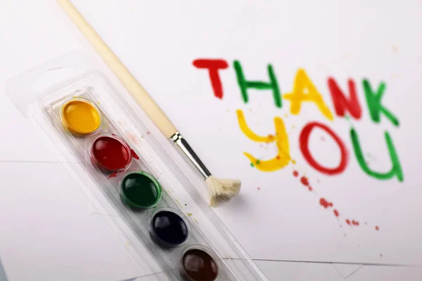 Inscription on white sheet of paper with watercolors "Thank you" — Stock Photo, Image