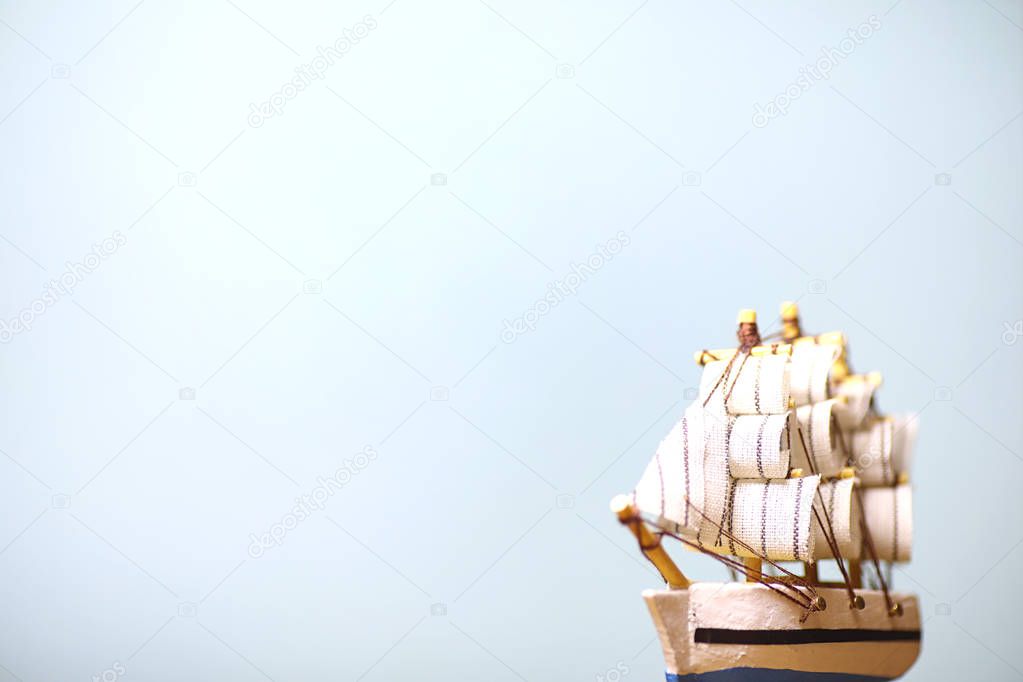 Old wooden ship with sails and masts toy on a stand. Vintage and