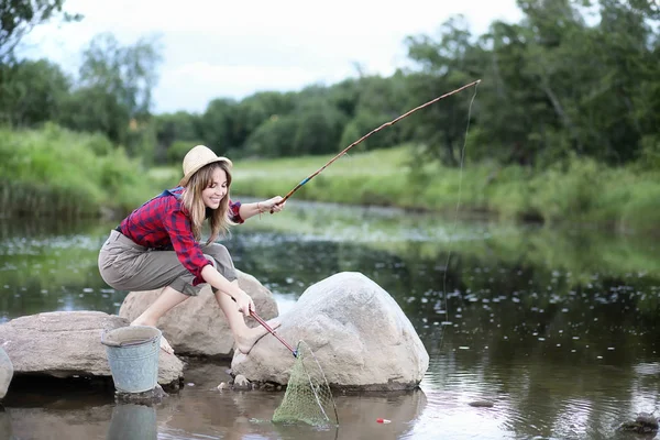 Ragazza vicino al fiume con una canna da pesca — Foto Stock