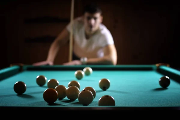 A man with a beard plays a big billiard. Party in a 12-foot pool — Stock Photo, Image