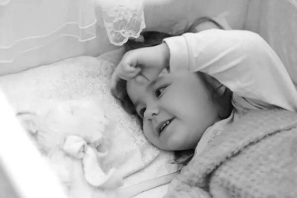 Little girl in bed on pillow — Stock Photo, Image