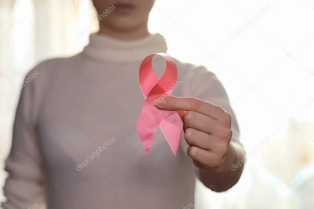 The red ribbon of the girl. The girl is holding a red ribbon. He