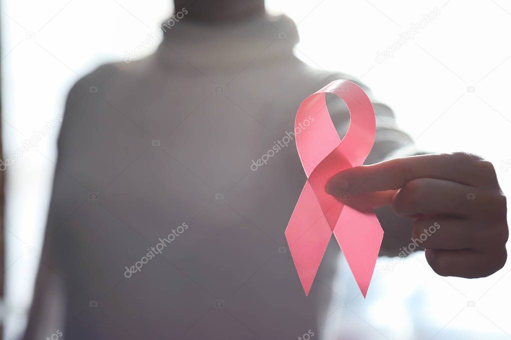 The red ribbon of the girl. The girl is holding a red ribbon. He