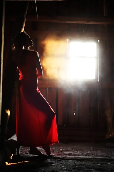 Silhouette of a beautiful girl in a red dress — Stock Photo, Image