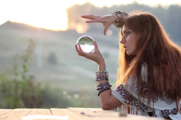 Witch with crystal ball at sunset — Stock Photo, Image