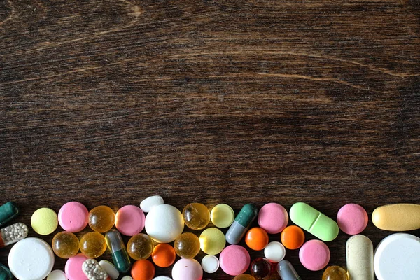 Medications on a textured wooden background — Stock Photo, Image