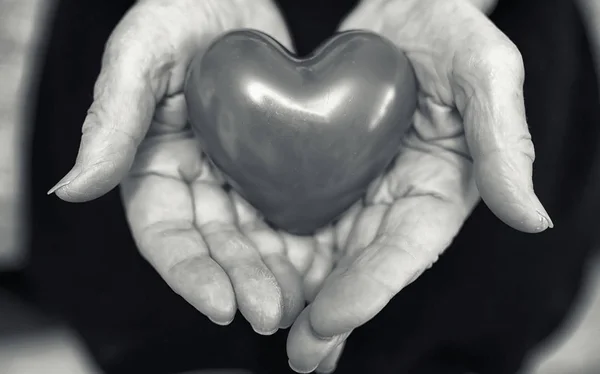 Elder woman holding heart — Stock Photo, Image