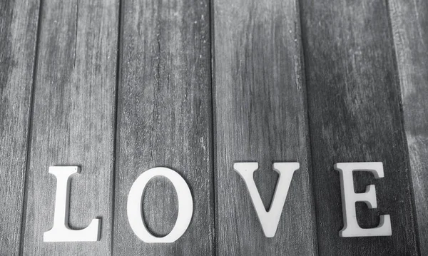 Word love made up of white wooden letters on a wooden background — Stock Photo, Image