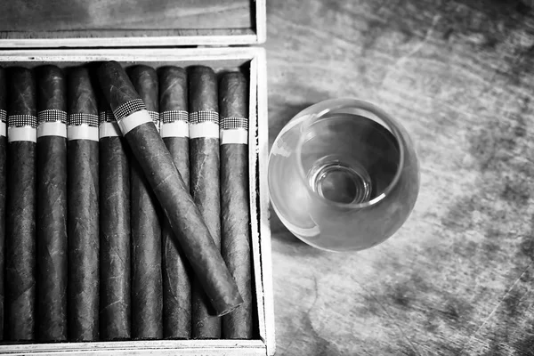 Retro styled photo of large box of Cuban cigars on a wooden tabl — Stock Photo, Image