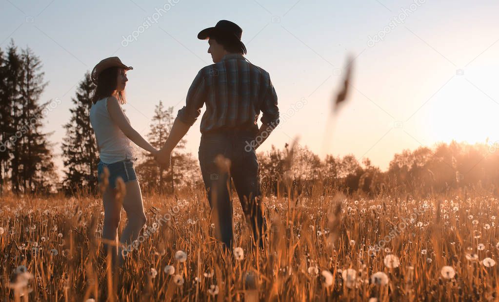 man and a girl are walking in the autumn