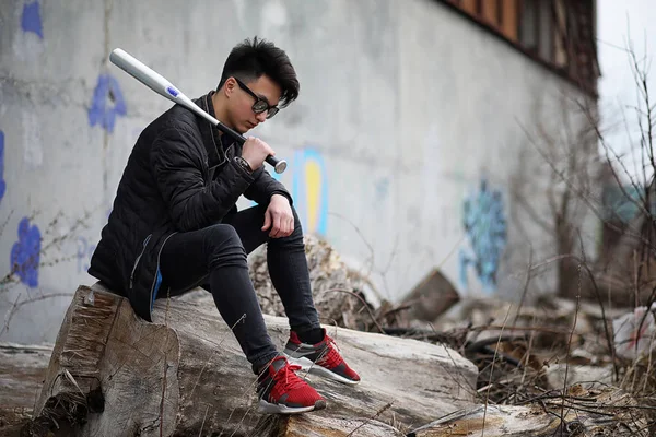 Asian young man on the street posing at the camera