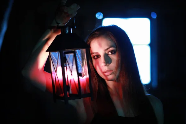 Beautiful girl with red hair with a lantern — Stock Photo, Image