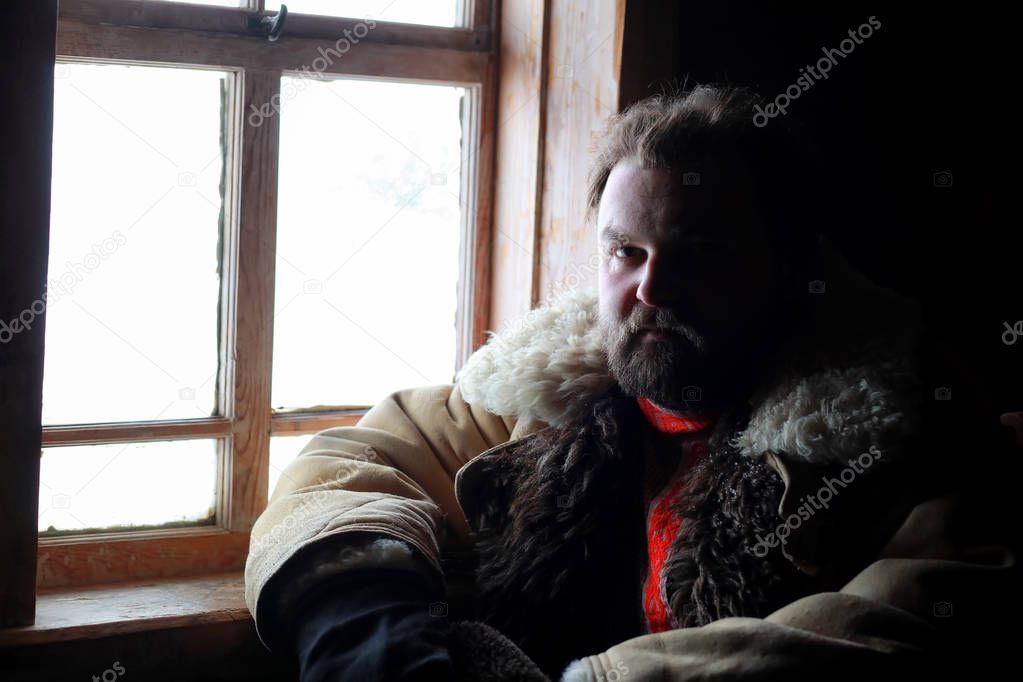 man in traditional winter costume of peasant medieval age in rus