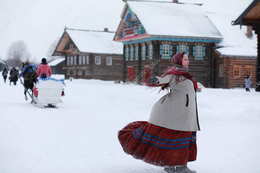 young girls in traditional costumes of the Russian north in wint