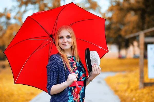 Mädchen auf der Straße mit einem Regenschirm — Stockfoto