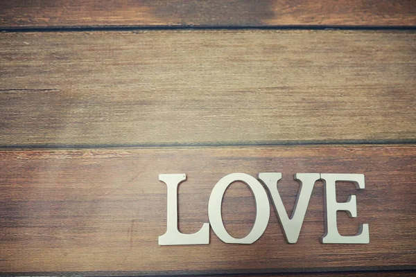 Ord Kærlighed fra træbogstaver på baggrund - Stock-foto