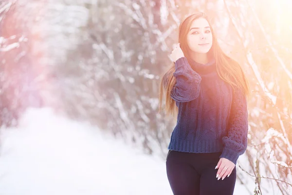 Una joven en un parque de invierno en un paseo. Vacaciones de Navidad en t —  Fotos de Stock