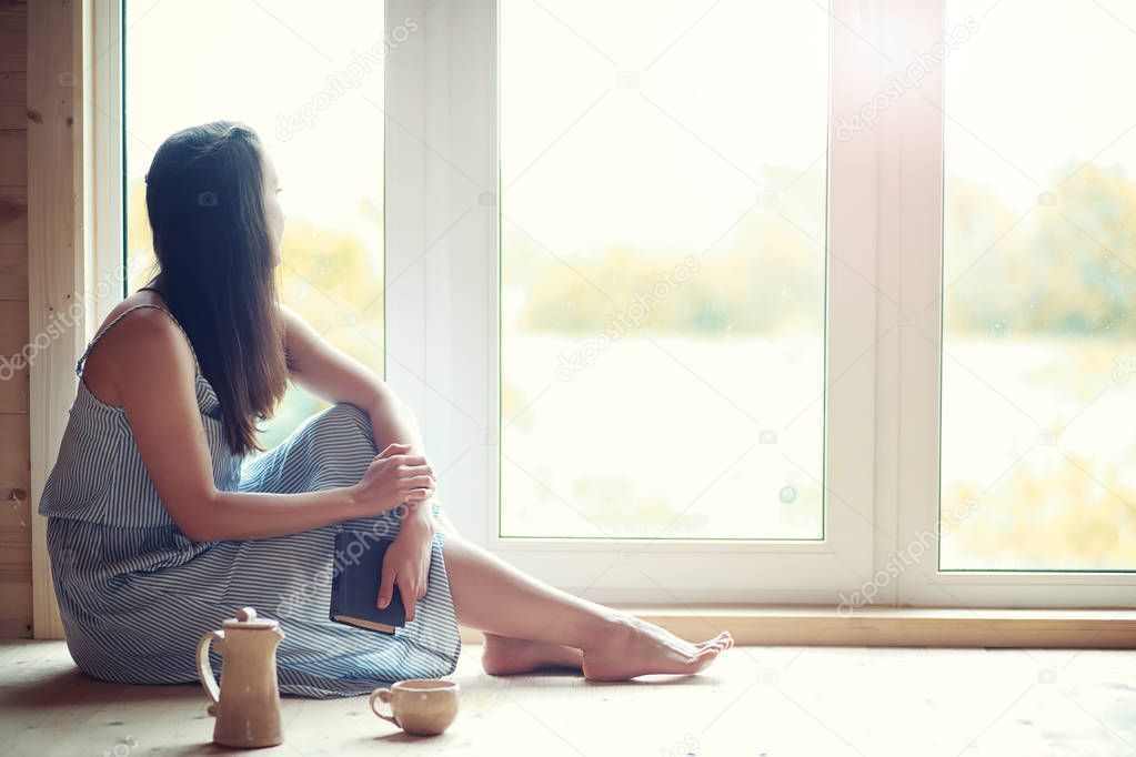 A girl at the window in the house