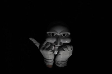 Siyah arka planda beyaz, korkunç bir maske..