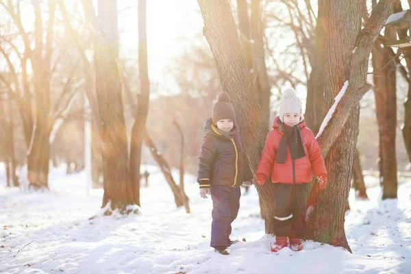 Niños en el parque de invierno jugar — Foto de Stock