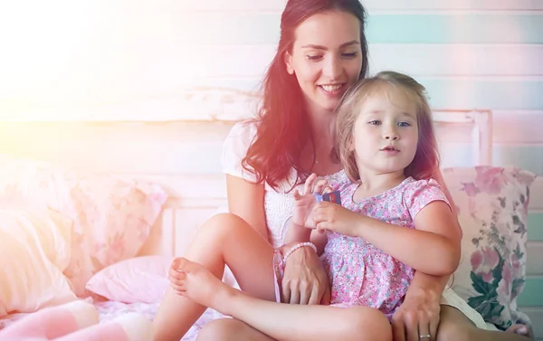 Young girl reads a book Young girl with a daughter are sitting o