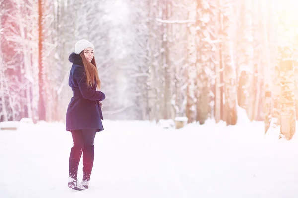 Ένα νεαρό κορίτσι σε ένα χειμερινό πάρκο για μια βόλτα. Χριστούγεννα στην t — Φωτογραφία Αρχείου