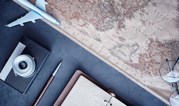 Travel concept. Map on the table and model aircraft.