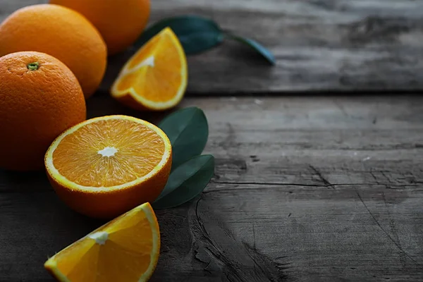 Orange citrus fruit on stone table. Orange background.