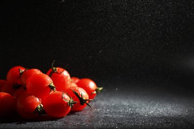Sprey siyah arka plan üzerinde Kiraz domates