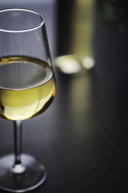 Masada şeffaf beyaz kuru şarap şişesi. Ahşap bir duvar arka plan üzerinde beyaz şarap cam.