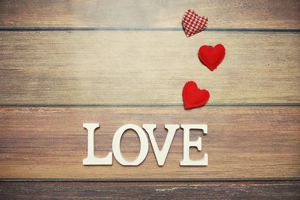 word Love from wooden letters on background