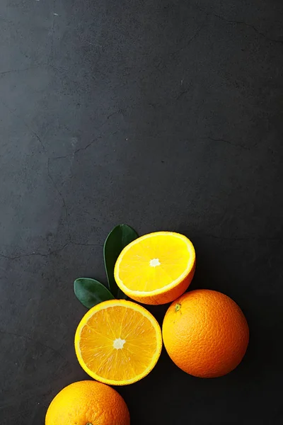 Orange citrus fruit on stone table. Orange background.