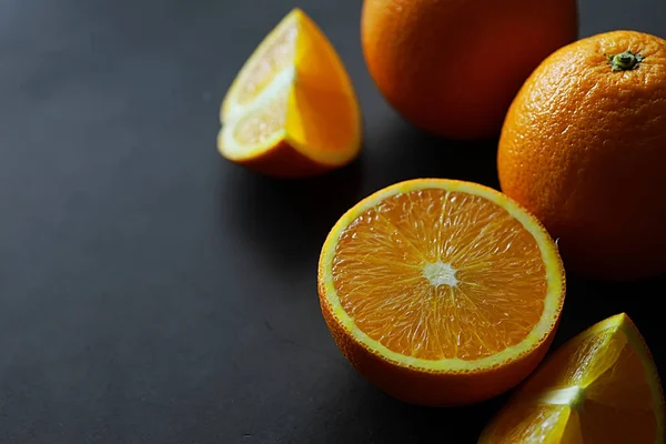 Orange citrus fruit on stone table. Orange background.