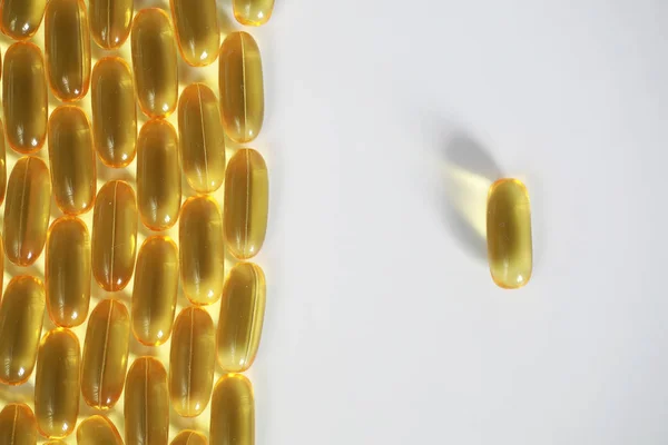 Medical drugs transparent capsules of yellow color — Stock Photo, Image