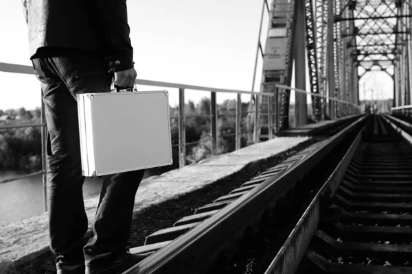 monochrome photo of a silver metal case with money transfer concep