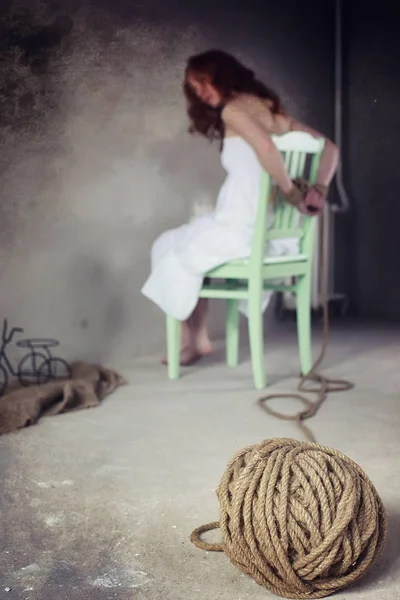 Genç kız yere bağlı. Kaçırılan kız. Kurban o