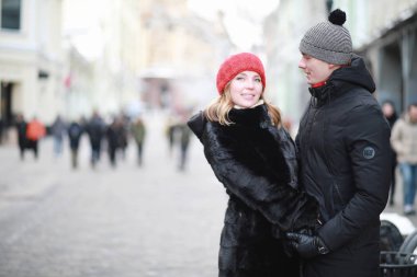 Young couple walking through the winter clipart