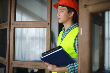 Kask ve inşaat koruyucu yelek Asyalı adam