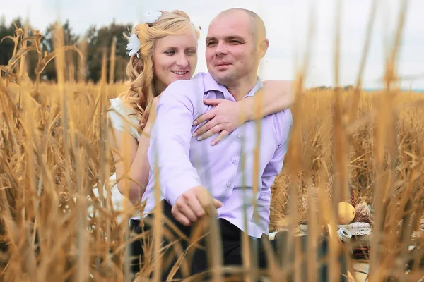 Just married lovers walking in a field in autumn day — Stock Photo, Image