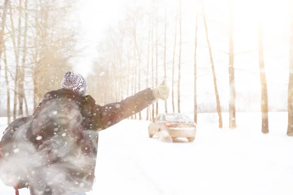 Man and car. Winter walk and car repair. — Stock Photo, Image