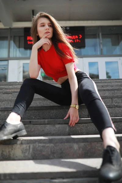 Una ragazza posa sui gradini di un edificio — Foto Stock