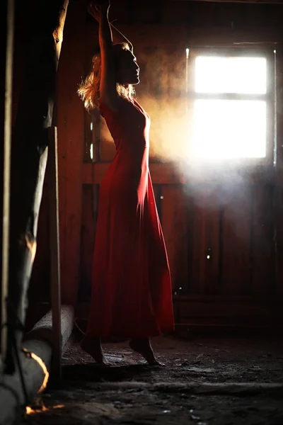 Silhouette of a beautiful girl in a red dress — Stock Photo, Image