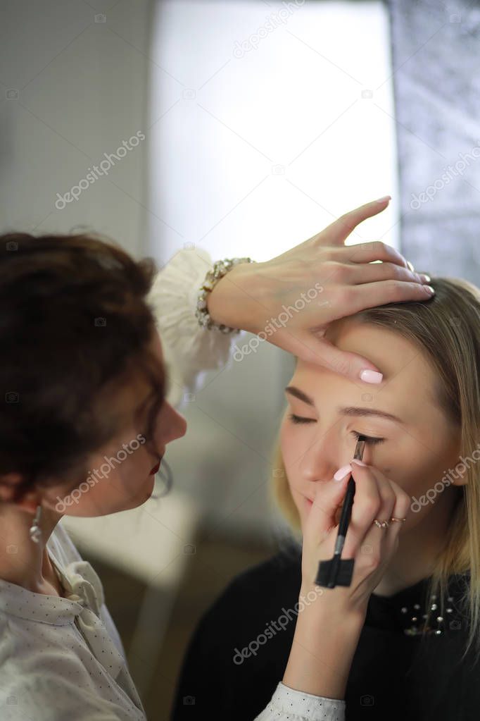 Young girl with a make-up artist