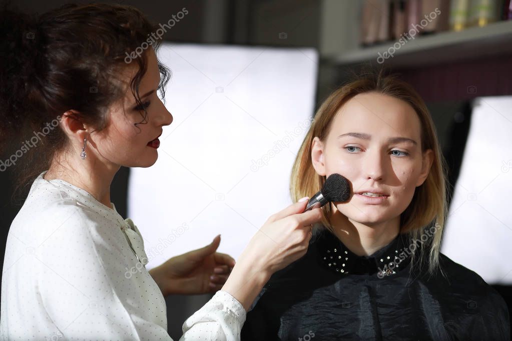 Young girl with a make-up artist