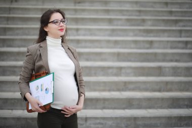 Hamile kadın sokakta telefonda söz