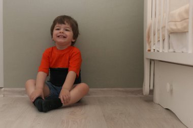 Bir katta bir odada oynayan genç çocuk